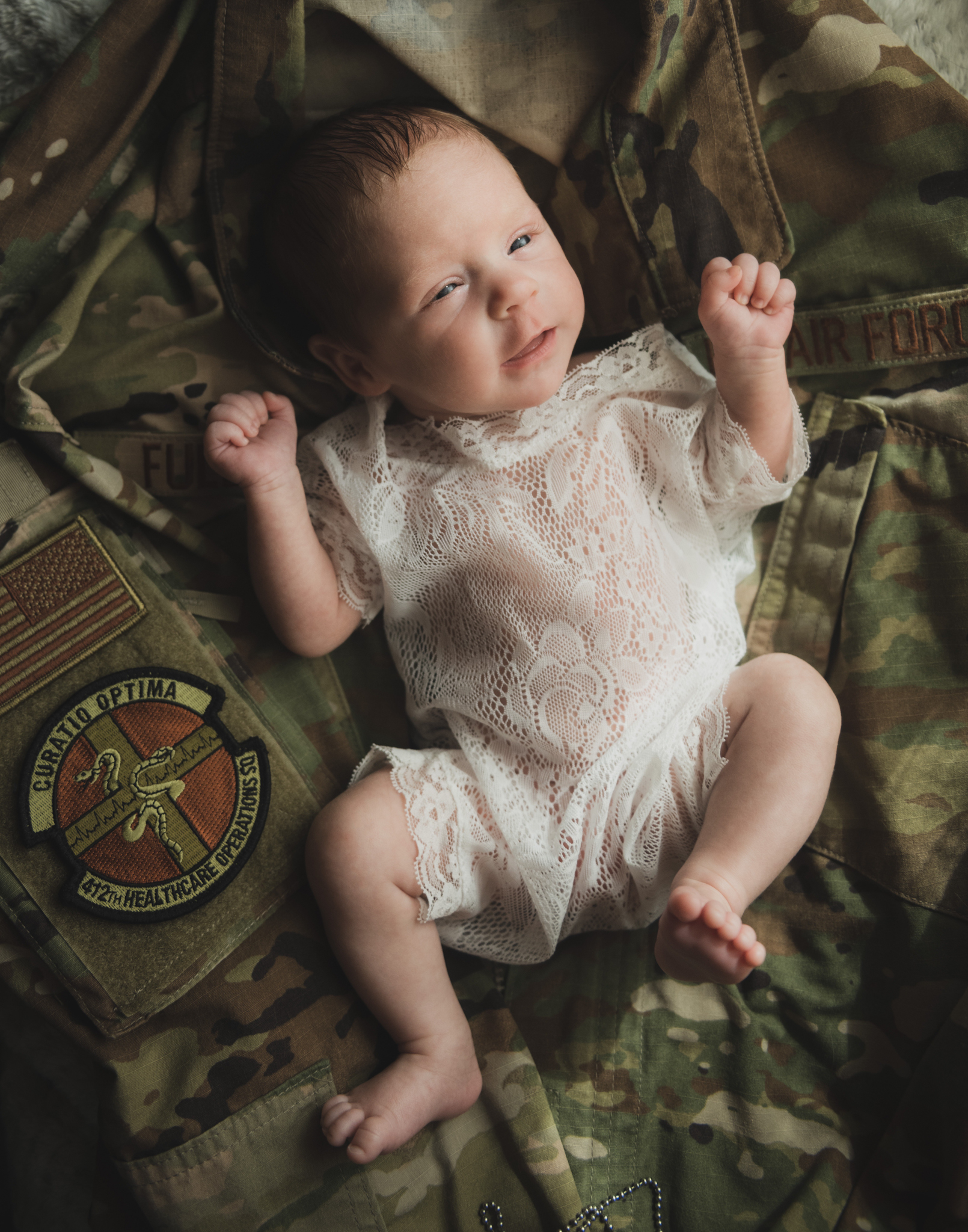 light and airy shoots of a marine baby shot on the air force base in southern california. Baby looks happy in her shoot with the high deserts best child photographer